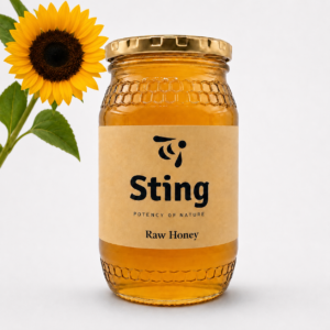Jar of Sting Raw Honey with a sunflower against a light background.