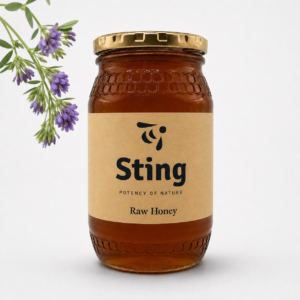 Jar of Sting Raw Honey with a lavender sprig on the left, beige label and gold cap visible